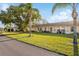 Community view of villas with palm trees and a paved pathway at 11445 Orleans Ln, Port Richey, FL 34668