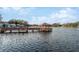Scenic lakefront view with a gazebo and dock, offering tranquility at 11445 Orleans Ln, Port Richey, FL 34668