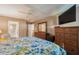 Main bedroom with a king-size bed, dresser, and ensuite bathroom access at 11445 Orleans Ln, Port Richey, FL 34668