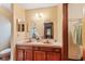 Bathroom with double sinks, wood cabinets, and a shower at 11505 Wild Cat Ln, New Port Richey, FL 34654