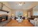 Living room with fireplace, hardwood floors, and vaulted ceiling at 11505 Wild Cat Ln, New Port Richey, FL 34654