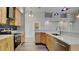 Bright kitchen with light wood cabinets, stainless steel appliances, and quartz countertops at 12903 Tinley Rd, New Port Richey, FL 34654