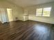 Living room with wood-look vinyl flooring and neutral walls at 13008 Fish Cove Dr, Spring Hill, FL 34609