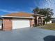 Brick house with white garage door and screened porch at 15131 Eastwood Trl, Brooksville, FL 34604
