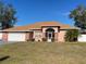 Brick house with brown roof, screened porch, and fenced backyard at 15131 Eastwood Trl, Brooksville, FL 34604