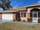 Brick house with white garage door and screened porch at 15131 Eastwood Trl, Brooksville, FL 34604