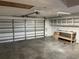 Spacious garage with overhead storage and workbench at 15131 Eastwood Trl, Brooksville, FL 34604