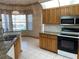 Bright kitchen with granite countertops and stainless steel appliances at 15131 Eastwood Trl, Brooksville, FL 34604