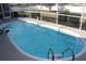 Blue kidney-shaped pool with screened enclosure at 15131 Eastwood Trl, Brooksville, FL 34604