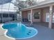Inviting kidney-shaped pool with screened enclosure at 15131 Eastwood Trl, Brooksville, FL 34604