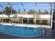 Sparkling kidney-shaped pool with screened enclosure at 15131 Eastwood Trl, Brooksville, FL 34604