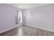 Purple bedroom with gray laminate flooring and window at 15920 Texarkana Pl, Spring Hill, FL 34610