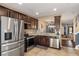 Spacious kitchen featuring stainless steel appliances and dark wood cabinets at 15933 Stable Run Dr, Spring Hill, FL 34610