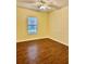 Well-lit bedroom with wood flooring and ceiling fan at 2199 Chianti Pl # 9-0917, Palm Harbor, FL 34683