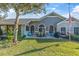 Spacious backyard patio with seating area, grill, and lush landscaping at 2595 Royal Liverpool Dr, Tarpon Springs, FL 34688