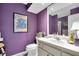 Purple bathroom with updated vanity and shower at 2595 Royal Liverpool Dr, Tarpon Springs, FL 34688
