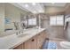 Elegant bathroom with double sinks, large shower, and updated fixtures at 2595 Royal Liverpool Dr, Tarpon Springs, FL 34688