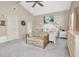 Bright main bedroom with king-size bed and sitting area at 2595 Royal Liverpool Dr, Tarpon Springs, FL 34688