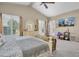 Main bedroom with king-size bed, sitting area, and golf course view at 2595 Royal Liverpool Dr, Tarpon Springs, FL 34688