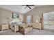 Spacious main bedroom with a king-size bed and sitting area at 2595 Royal Liverpool Dr, Tarpon Springs, FL 34688