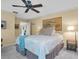 Spacious bedroom with ceiling fan and en-suite bathroom at 2595 Royal Liverpool Dr, Tarpon Springs, FL 34688
