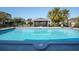 Inviting community pool with lounge chairs and a screened gazebo at 2595 Royal Liverpool Dr, Tarpon Springs, FL 34688