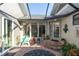 Inviting courtyard with brick pavers, fountain, and seating area at 2595 Royal Liverpool Dr, Tarpon Springs, FL 34688