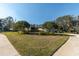 Tan house with lush landscaping at 2595 Royal Liverpool Dr, Tarpon Springs, FL 34688