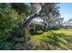 House exterior with a screened patio and lush landscaping at 2595 Royal Liverpool Dr, Tarpon Springs, FL 34688