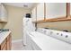 Laundry room with washer, dryer, and extra storage at 2595 Royal Liverpool Dr, Tarpon Springs, FL 34688