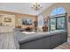 Living area with gray sectional and chandelier at 2595 Royal Liverpool Dr, Tarpon Springs, FL 34688