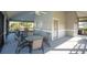 Covered patio area with tables and chairs near the community pool at 2595 Royal Liverpool Dr, Tarpon Springs, FL 34688