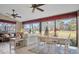 Spacious sunroom with golf course view, seating, and dining area at 2595 Royal Liverpool Dr, Tarpon Springs, FL 34688