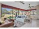 Bright sunroom with golf course view and comfy seating at 2595 Royal Liverpool Dr, Tarpon Springs, FL 34688