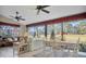 Spacious sunroom with golf course view, seating, and dining area at 2595 Royal Liverpool Dr, Tarpon Springs, FL 34688