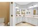 Large bathroom with double sinks, a toilet, and white cabinets at 2902 Punta Palma Ct, Holiday, FL 34691
