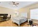 Bright bedroom with hardwood floors, a queen-size bed, and a workspace at 2902 Punta Palma Ct, Holiday, FL 34691