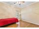 Bright bedroom featuring wood floors and a ceiling fan at 2902 Punta Palma Ct, Holiday, FL 34691