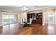 Elegant dining room with hardwood floors, glass table, and built-in shelving at 2902 Punta Palma Ct, Holiday, FL 34691