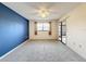 Bedroom with blue accent wall, carpet flooring, and sliding glass doors at 3417 Lori Ln # 2, New Port Richey, FL 34655