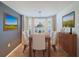 Elegant dining room with a wood table and six white chairs at 3417 Lori Ln # 2, New Port Richey, FL 34655