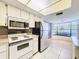 Kitchen boasts white cabinets, granite countertops, and a breakfast nook at 3417 Lori Ln # 2, New Port Richey, FL 34655