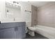 Modern bathroom with gray vanity and bathtub at 4712 Stonepointe Pl, Tampa, FL 33634