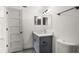 Modern bathroom with gray vanity, updated fixtures, and a white toilet at 4712 Stonepointe Pl, Tampa, FL 33634