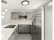 Updated kitchen featuring gray cabinets and a breakfast bar at 4712 Stonepointe Pl, Tampa, FL 33634