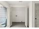 Clean laundry room with gray flooring and built-in shelving at 4712 Stonepointe Pl, Tampa, FL 33634