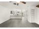Open concept living room with grey flooring, kitchen, and built-in shelving at 4712 Stonepointe Pl, Tampa, FL 33634