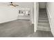 Spacious living room with grey flooring, fireplace, and kitchen view at 4712 Stonepointe Pl, Tampa, FL 33634
