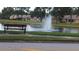 Peaceful lakefront community with scenic fountain and bench at 4737 Sandpointe Dr, New Port Richey, FL 34655