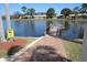 Brick path to a community dock on a lake at 4737 Sandpointe Dr, New Port Richey, FL 34655